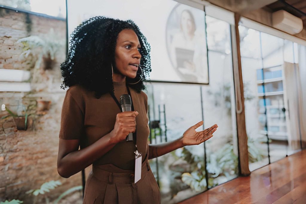 Black professional women speaking at a board meeting